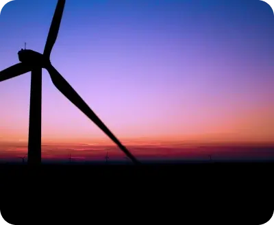 Silhouette of wind turbine at sunset